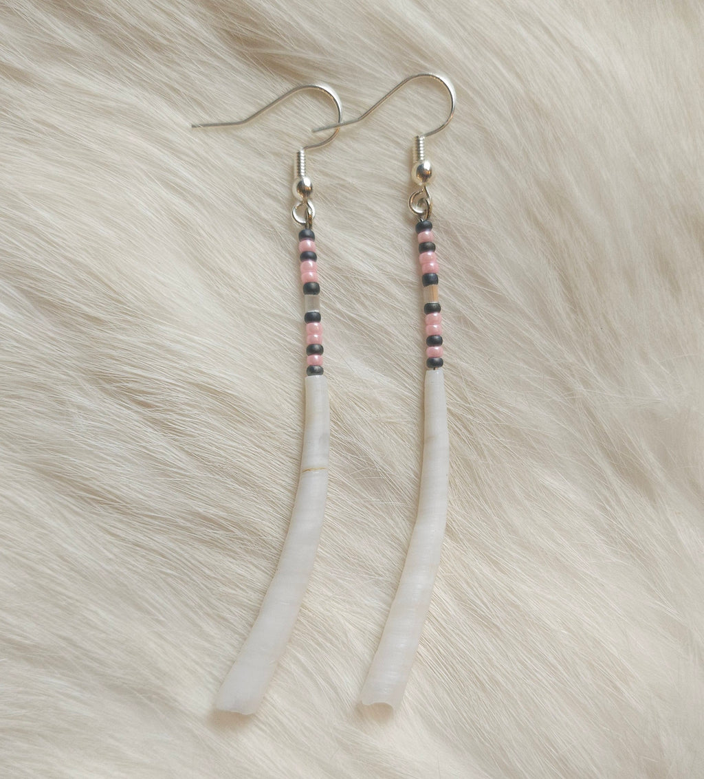 Pair of beaded earrings on a fur surface